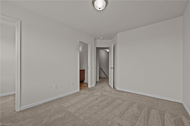 unfurnished bedroom featuring carpet floors and baseboards