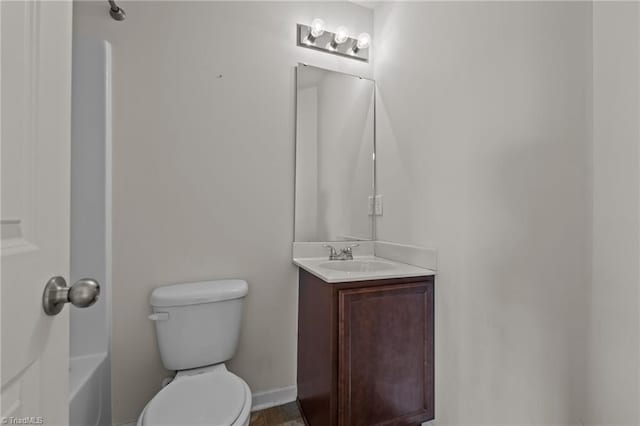 full bathroom featuring baseboards, vanity, and toilet