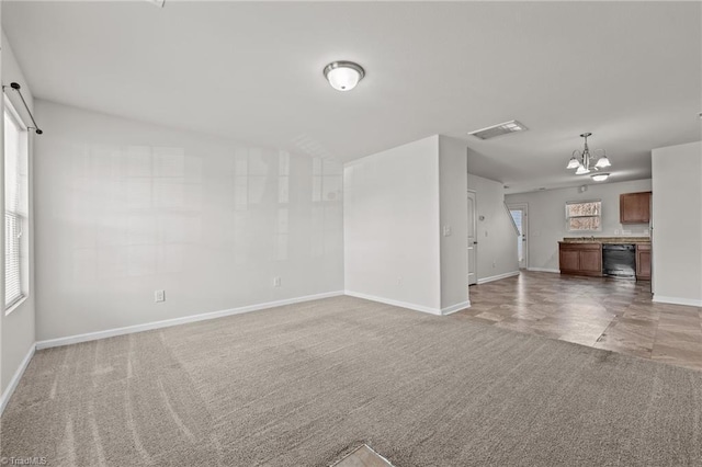 unfurnished living room with light carpet, plenty of natural light, and visible vents