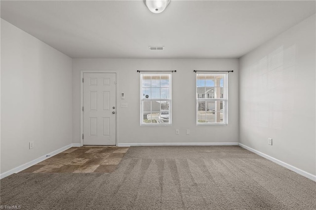 carpeted empty room with visible vents and baseboards