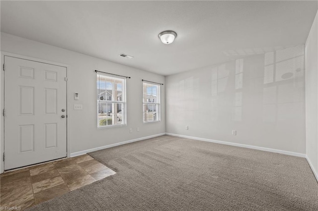 carpeted foyer with visible vents and baseboards