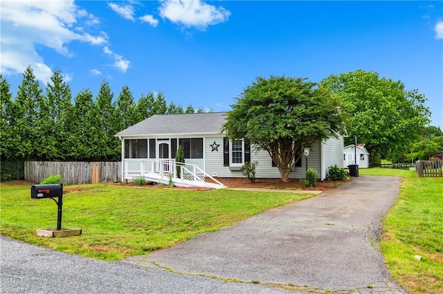 1118 Still Meadows Ln, King, NC 27021 - single story home featuring asphalt driveway, a sunroom, and roof with shingles