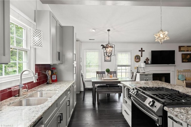 1118 Still Meadows Ln, King, NC 27021 - kitchen with stainless steel gas stove, a sink, healthy amount of natural light, and a chandelier
