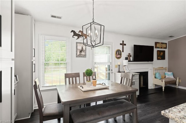 1118 Still Meadows Ln, King, NC 27021 - dining room featuring ornamental molding, healthy amount of natural light, a fireplace, a chandelier, and dark wood-style floors