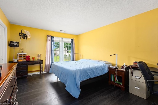 1118 Still Meadows Ln, King, NC 27021 - bedroom featuring dark wood-type flooring and a textured ceiling