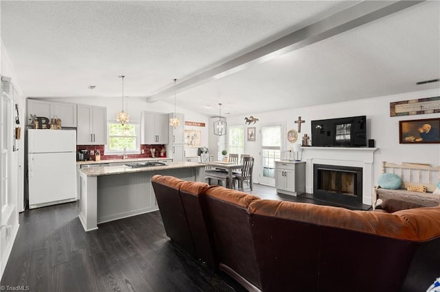 1118 Still Meadows Ln, King, NC 27021 - living room featuring dark wood-style flooring, a textured ceiling, and a fireplace with raised hearth
