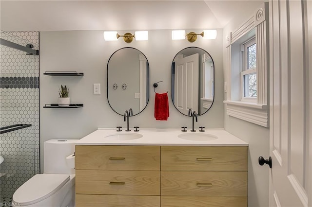 full bathroom featuring walk in shower, double vanity, toilet, and a sink