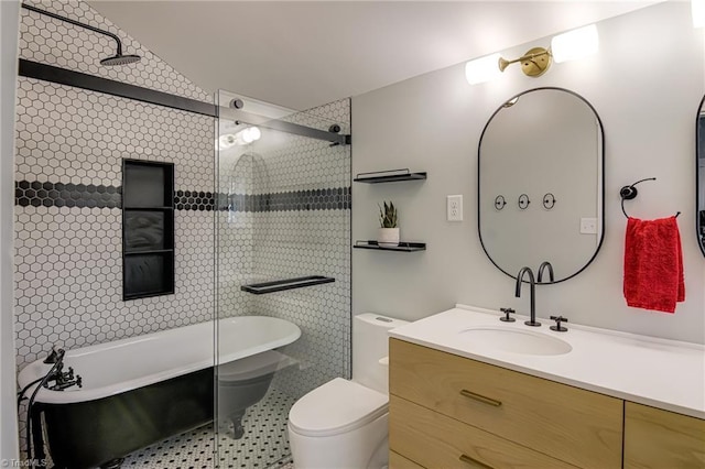 full bath featuring vanity, a freestanding tub, toilet, and walk in shower