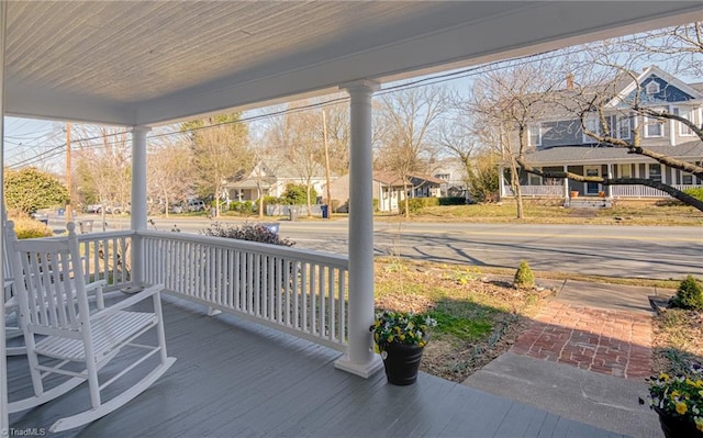 wooden deck featuring a residential view and a porch