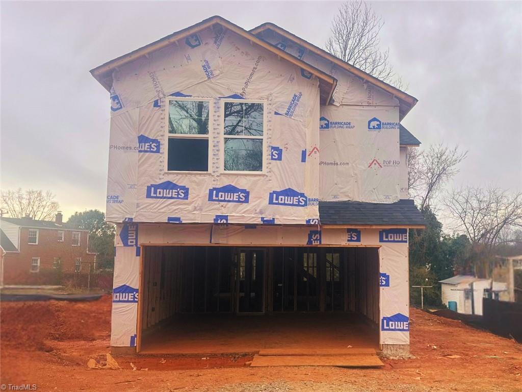 back of house featuring an attached garage