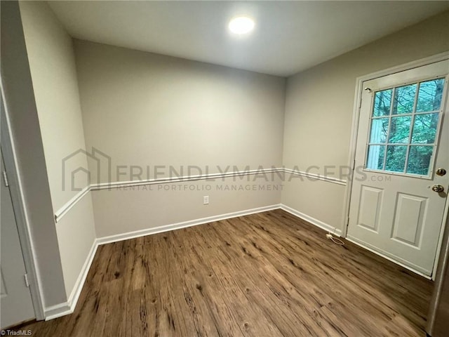 empty room with hardwood / wood-style floors