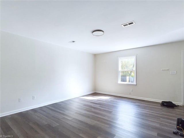 spare room with dark hardwood / wood-style floors