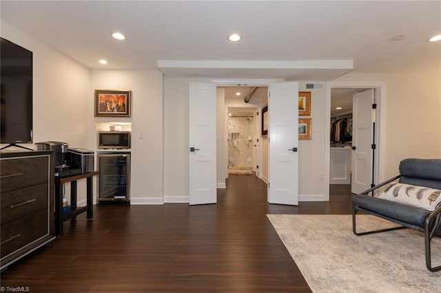 4166 Lytchfield Ct, Winston-Salem, NC 27104 - living area with beverage cooler, recessed lighting, dark wood-style floors, and baseboards