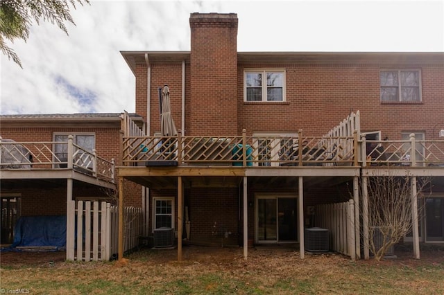 4166 Lytchfield Ct, Winston-Salem, NC 27104 - back of house with a chimney, a wooden deck, brick siding, and central AC unit