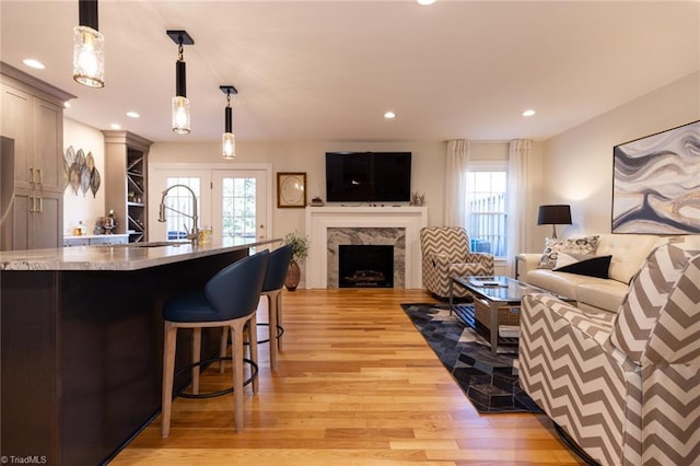 4166 Lytchfield Ct, Winston-Salem, NC 27104 - living room with light wood finished floors, plenty of natural light, a fireplace, and recessed lighting
