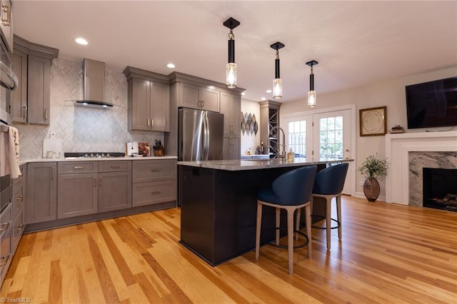 4166 Lytchfield Ct, Winston-Salem, NC 27104 - kitchen with gray cabinets, wall chimney exhaust hood, freestanding refrigerator, light wood-style flooring, and recessed lighting