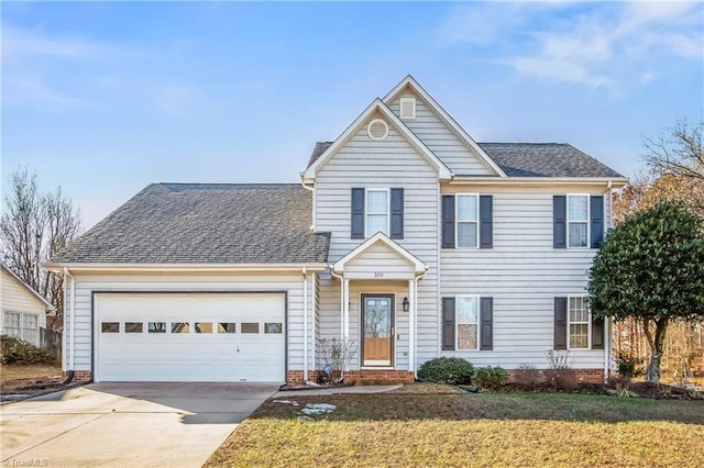 view of property with a garage and a front lawn