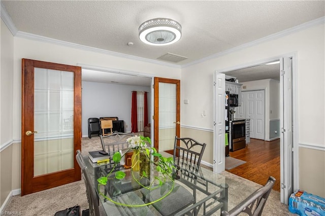 dining room featuring crown molding, french doors, and a textured ceiling