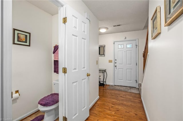 corridor with light wood-type flooring