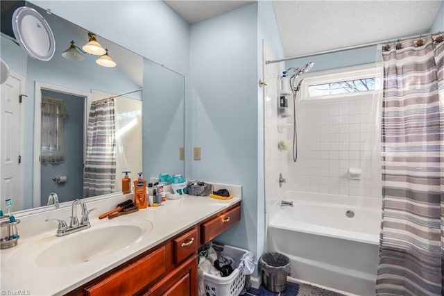 bathroom with vanity, a textured ceiling, and shower / bath combo with shower curtain