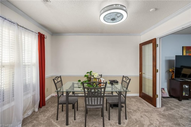 dining area featuring french doors, light colored carpet, ornamental molding, and a textured ceiling