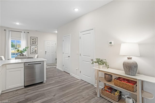 1868 Autumn Mist Dr, Winston-Salem, NC 27103 - kitchen with stainless steel dishwasher, light wood-type flooring, white cabinets, light countertops, and recessed lighting