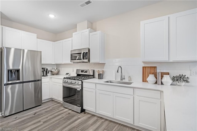1868 Autumn Mist Dr, Winston-Salem, NC 27103 - kitchen with stainless steel appliances, light countertops, white cabinets, and recessed lighting