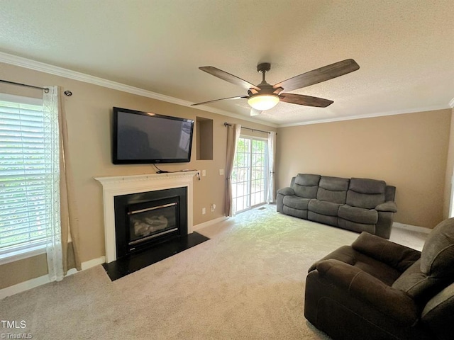 208 Mallard Creek Dr, Graham, NC 27253 - carpeted living room featuring a fireplace with flush hearth, a textured ceiling, crown molding, baseboards, and a ceiling fan