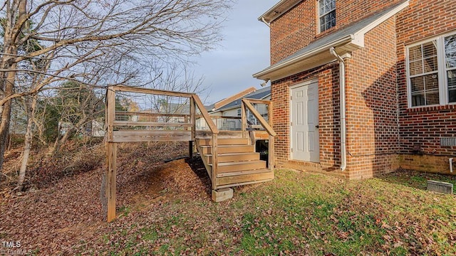 208 Mallard Creek Dr, Graham, NC 27253 - view of home's exterior with brick siding, a wooden deck, and stairs