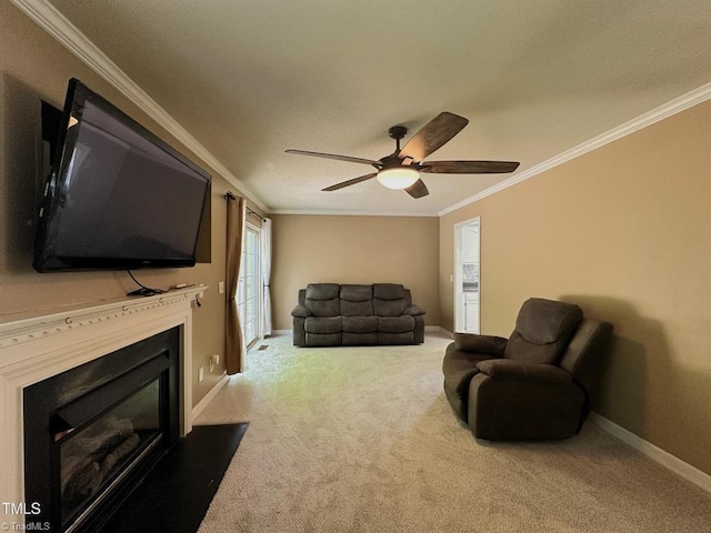 208 Mallard Creek Dr, Graham, NC 27253 - carpeted living area featuring a glass covered fireplace, crown molding, a ceiling fan, and baseboards