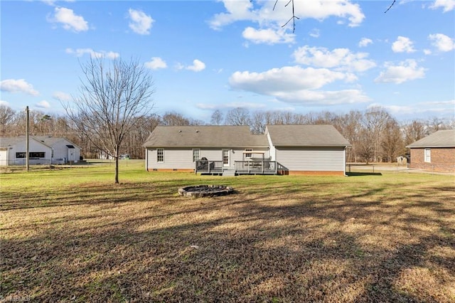 back of house with a yard and a deck