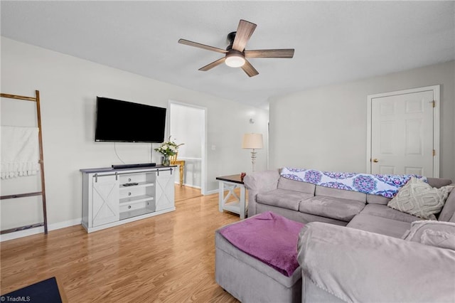 living room featuring ceiling fan and light hardwood / wood-style flooring