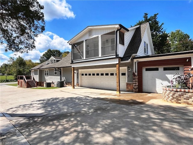 view of front facade with central AC unit and a garage