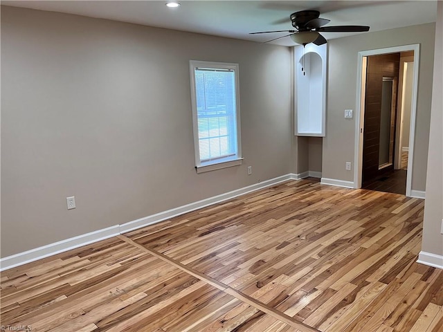 spare room featuring light hardwood / wood-style floors and ceiling fan