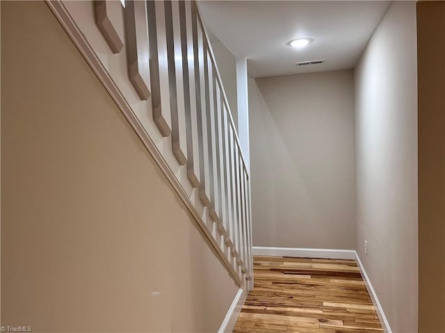 staircase with wood-type flooring