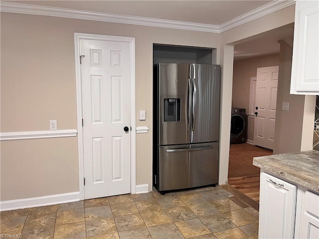 kitchen featuring washer / dryer, stainless steel fridge with ice dispenser, white cabinets, light hardwood / wood-style flooring, and ornamental molding