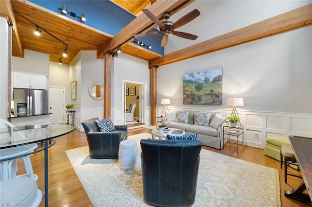 living room with track lighting, ceiling fan, wooden ceiling, and light wood-style floors