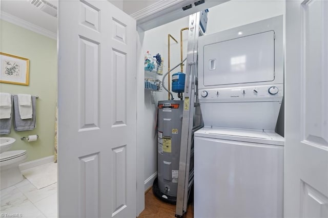 clothes washing area featuring visible vents, water heater, stacked washer / dryer, baseboards, and laundry area