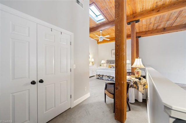 carpeted bedroom featuring wooden ceiling, baseboards, visible vents, and lofted ceiling with skylight