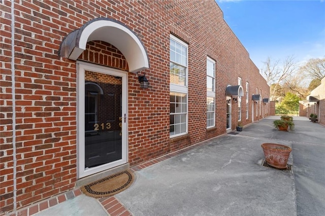 property entrance featuring brick siding