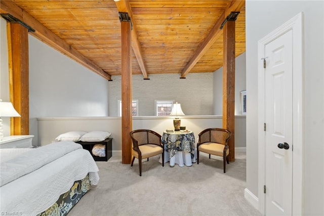 carpeted bedroom featuring beam ceiling, baseboards, and wooden ceiling