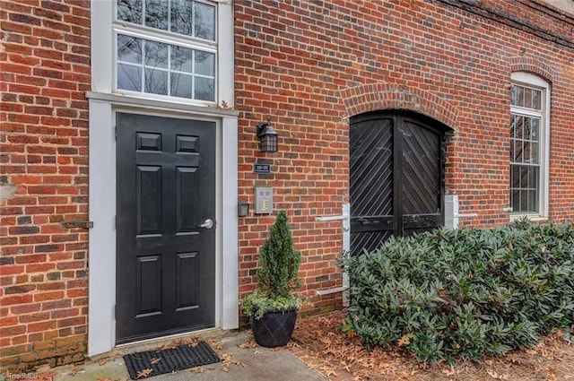 property entrance with brick siding