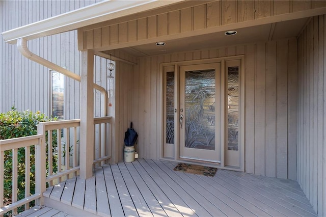 view of exterior entry with a wooden deck