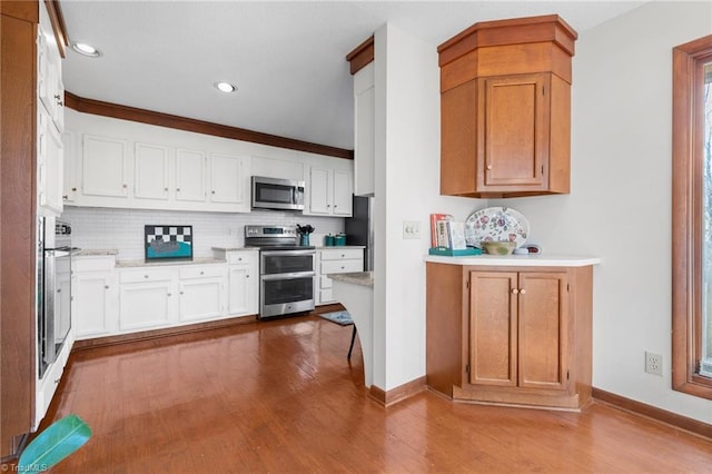 kitchen featuring tasteful backsplash, appliances with stainless steel finishes, and dark wood-type flooring