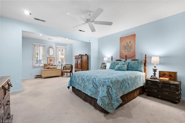 bedroom featuring visible vents, light colored carpet, a ceiling fan, and baseboards