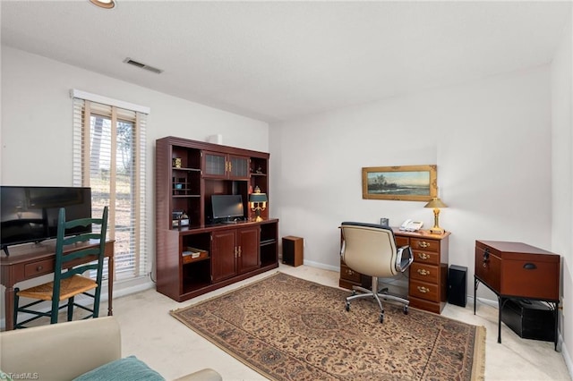 office space featuring light carpet, visible vents, and baseboards