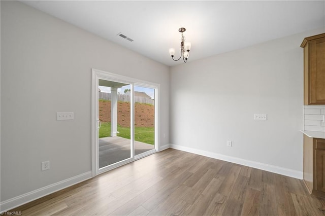 5751 Siler St, Trinity, NC 27370 - unfurnished dining area featuring visible vents, light wood-style floors, baseboards, and a notable chandelier