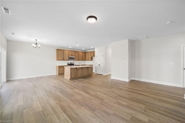 5751 Siler St, Trinity, NC 27370 - kitchen featuring visible vents, open floor plan, light countertops, a chandelier, and stainless steel appliances