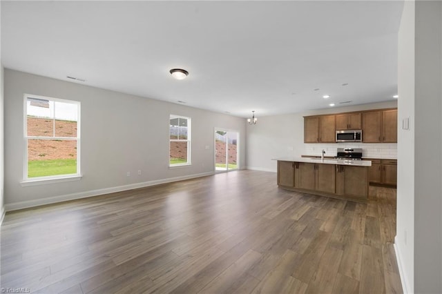 5751 Siler St, Trinity, NC 27370 - kitchen with open floor plan, appliances with stainless steel finishes, a chandelier, and a wealth of natural light