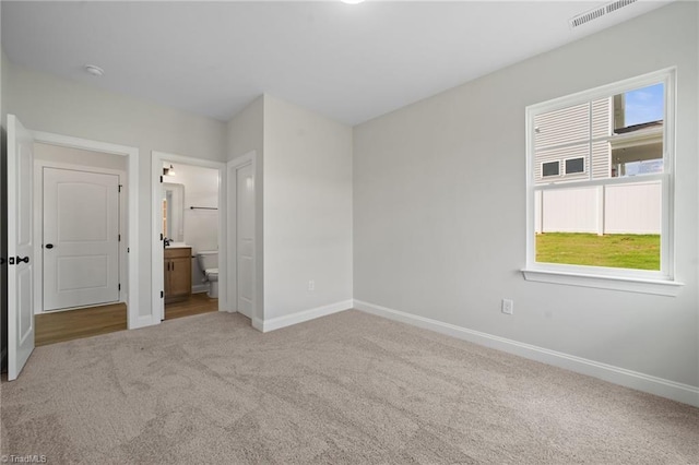5751 Siler St, Trinity, NC 27370 - unfurnished bedroom featuring carpet flooring, baseboards, visible vents, and ensuite bath